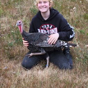 Claire with her turkey in the grass