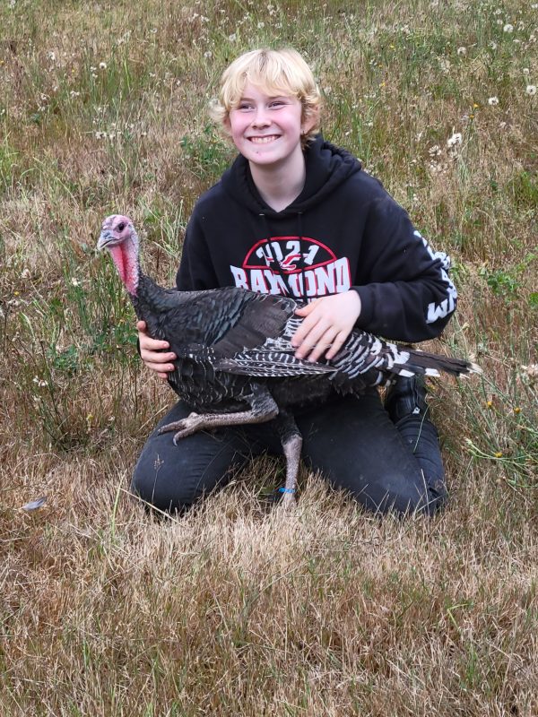 Claire with her turkey in the grass